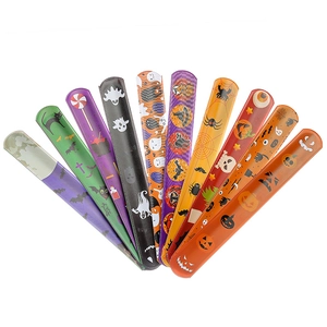 Various Halloween slap bracelets featuring pumpkin, ghost, and bat prints for festive fun