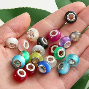 Macro view of colorful large hole resin beads held in hand for DIY jewelry making
