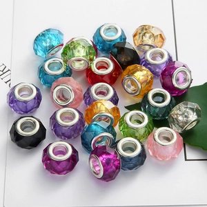 Macro detail of multi-faceted crystal glass large hole spacer beads in vibrant assorted colors