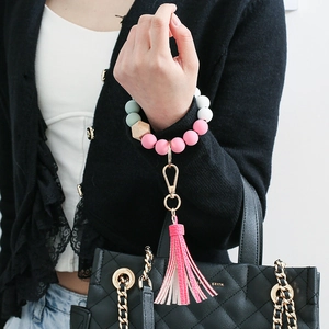 Pink and green silicone beaded wristlet keychain with wooden bead and bicolor tassel detail