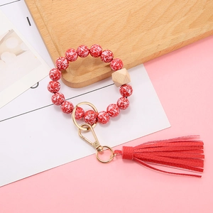 Floral wood bead bracelet keychain with red tassels and gold metal clasp accessory