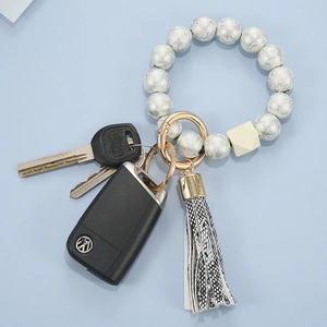 Floral patterned bead bracelet keychain with leather tassel and gold ring clip