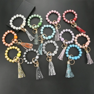 Various colorful silicone bead keychain bracelets with tassels and hexagon wooden beads