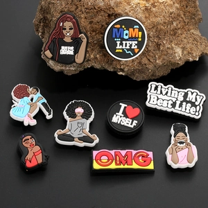 8-piece set of Black Girl Magic PVC shoe charms for clogs on dark rock background