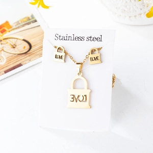 Detailed view of golden stainless steel jewelry set with heart lock and LOVE engraving