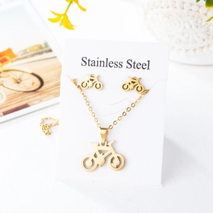 Golden stainless steel bicycle jewelry set with necklace and earrings on a white card