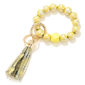 Close-up of beaded keychain bracelet with lace patterns and snake print tassel detail