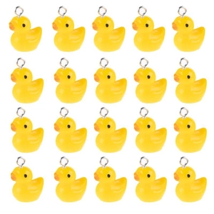 Detailed grid view of twenty yellow resin duck pendants with metal hooks on white background
