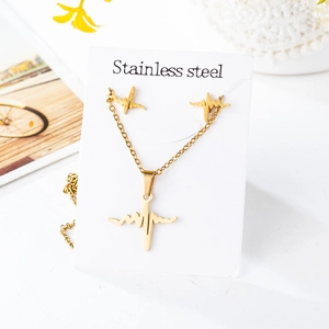 Detail view of gold stainless steel necklace and earring set with heartbeat pattern