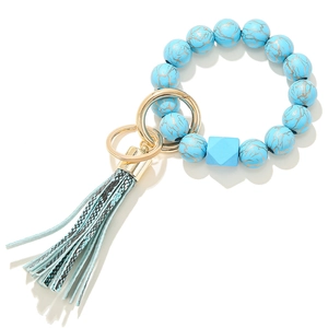 Detail of blue marble wood bead keychain with elegant tassel and gold ring clasp