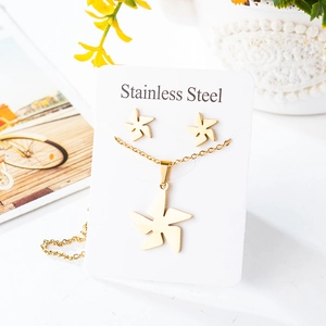 Detail showing golden stainless steel windmill necklace and stud earrings jewelry set