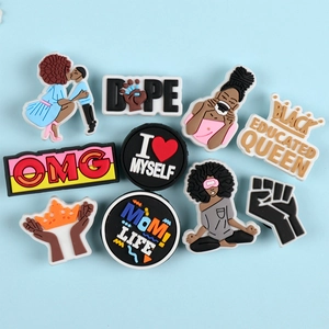 Detail of African American themed PVC shoe charms featuring Black Queen and Mom designs