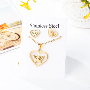 Detail of gold stainless steel jewelry set with hollow heart and butterfly designs