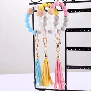 Pulsera llavero de cuentas de silicona Morandi con cuenta de madera y borla de cuero