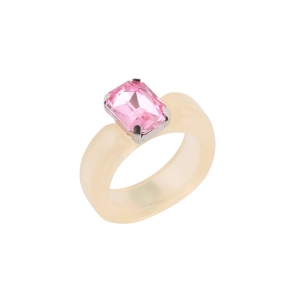 Close-up of cream resin ring featuring a pink rectangular crystal in a silver claw setting