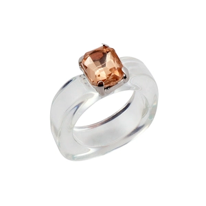 Macro shot of transparent resin ring with champagne rectangular gem in a claw setting