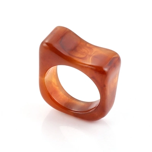 Macro shot of thick amber resin ring with tortoise shell texture and smooth edges