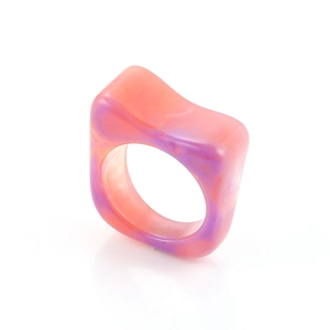 Detail of pink and purple marble resin ring with a wide geometric square design