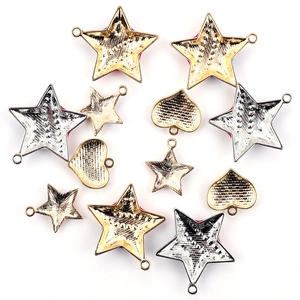 Detailed view of gold and silver alloy heart and star charms for DIY jewelry making