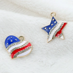 Macro view of heart and star pendants with US flag enamel and sparkling rhinestones