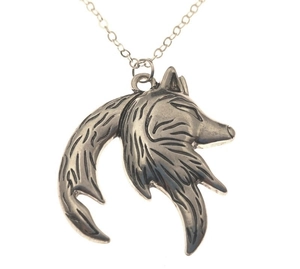 Close-up of vintage wolf head pendant with oxidized textures and silver finish