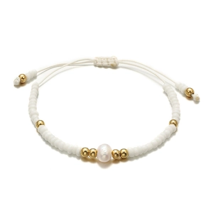 Close-up of handmade beaded bracelet with freshwater pearl and adjustable white cord