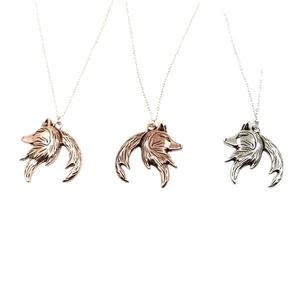 Wolf head and moon pendant necklace set in bronze, rose gold, and silver finishes