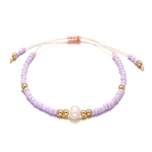 Detail of lavender seed bead bracelet with freshwater pearl and gold accents