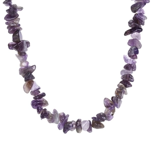 Macro detail of natural crushed purple amethyst stones on a Hawaiian style necklace