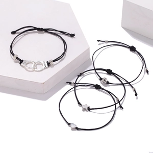 Adjustable black woven rope bracelet set with handcuffs, star and heart charms
