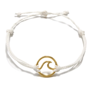 Close-up of handmade woven white cord bracelet with a golden circular wave pendant