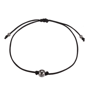 Handmade woven black cord bracelet set with metallic bead accents in minimalist style