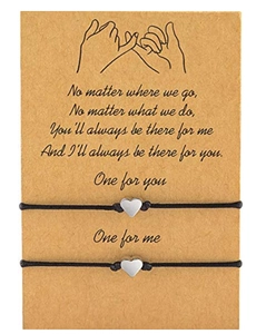 Detail showing two handmade heart charm bracelets on a kraft paper gift display card