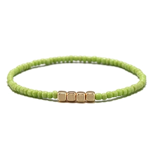 Bracciale bohémien con perline verdi e piccoli cubi metallici dorati per donna