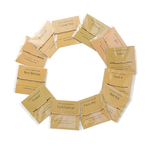Set of 12 Morse code bracelets with gold beads and woven ropes on display cards