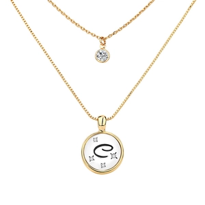 Detail of double-layer gold necklace featuring a zircon pendant and letter C coin charm