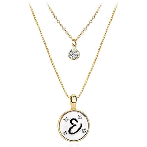 Macro view of double-layer gold letter E pendant necklace with sparkling zircon accents