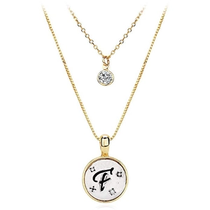 Detail of double-layer gold necklace featuring a zircon pendant and letter F disk