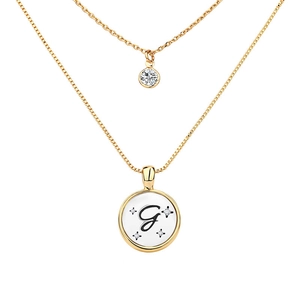 Close-up of golden double-layer necklace with letter G disc pendant and zircon stone