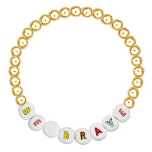 Detailed view of beaded bracelet with gold beads and BE BRAVE letter charms