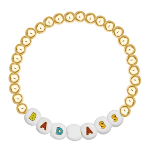 Detail of beaded bracelet featuring gold-polished beads and BADASS letter charms