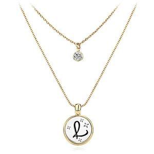 Detail of double-layer gold necklace with round zircon and disc pendant featuring letter L