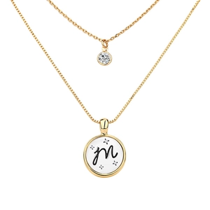 Detail of double-layer gold necklace featuring letter M pendant and small zircon stone