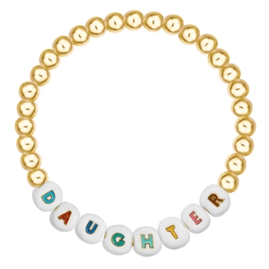 Detailed macro view of beaded bracelet with golden spheres and DAUGHTER letter beads