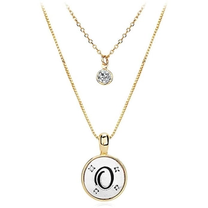 Detail of double-layer gold necklace featuring O-letter disc pendant and zircon stones