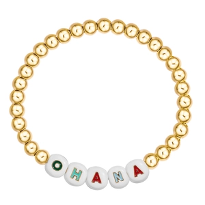 Detailed macro view of elastic gold beaded bracelet with colorful OHANA letter beads