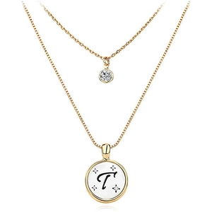 Detail of double-layer gold necklace with clear zircon and letter T medallion pendant