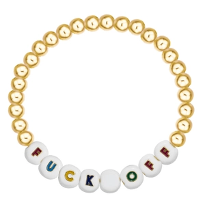 Close-up of golden beaded bracelet with colorful letter beads spelling a bold message
