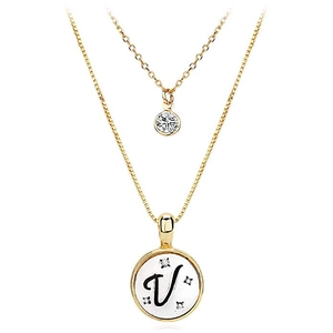 Close-up of double-layer gold necklace featuring a zircon charm and white shell V pendant