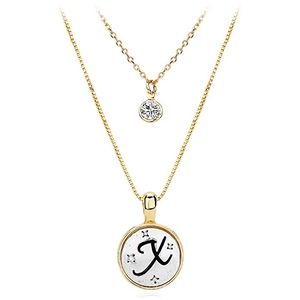 Detail of gold double-layer necklace with X-letter round pendant and sparkling zircons
